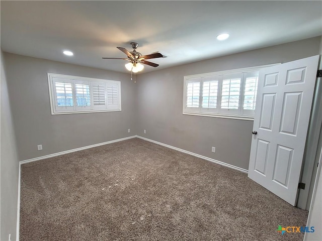 carpeted empty room featuring ceiling fan