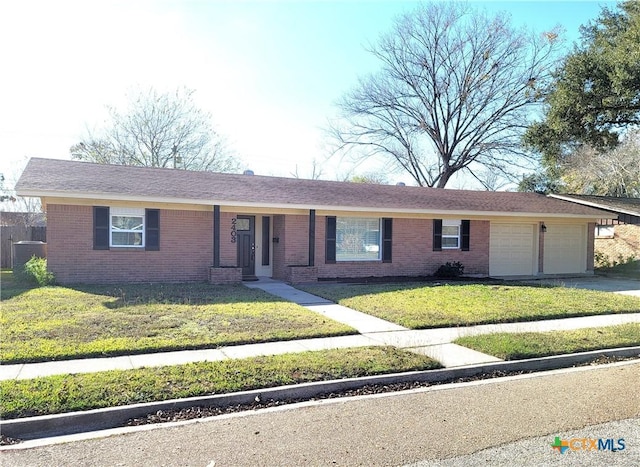 single story home featuring a front yard and a garage