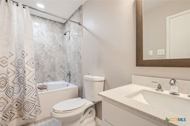 full bathroom with vanity, shower / tub combo, and toilet