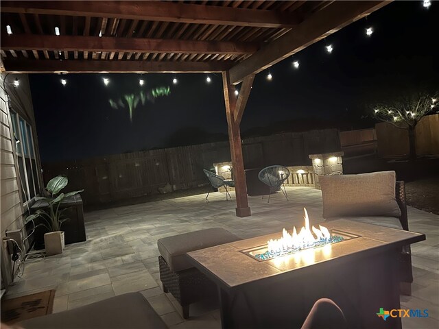 patio at night with an outdoor fire pit