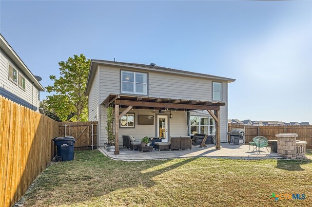 rear view of house with a patio, outdoor lounge area, and a yard