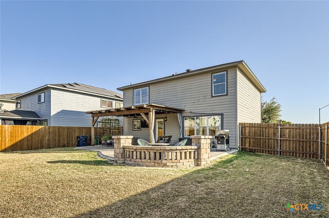 back of house with a patio area and a lawn