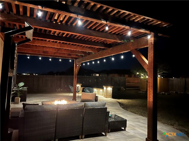 view of patio / terrace with a pergola and an outdoor living space with a fire pit