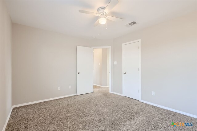 unfurnished bedroom featuring carpet floors and ceiling fan