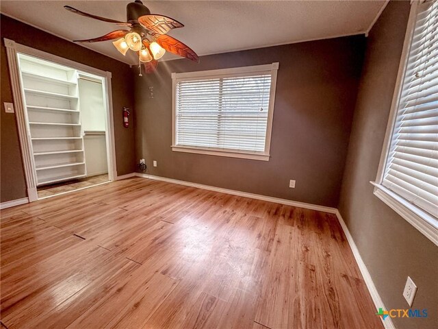 unfurnished room with ceiling fan and light hardwood / wood-style flooring