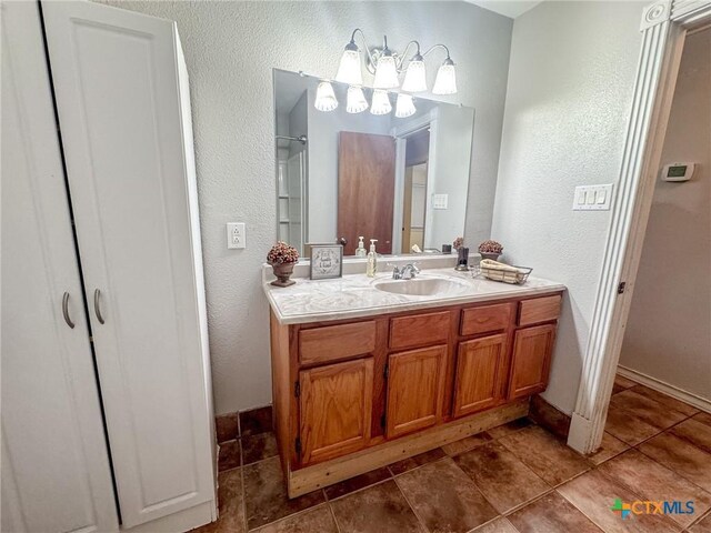 bathroom with tile patterned floors and vanity