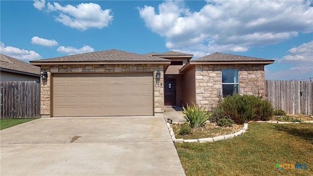 view of front facade with a front yard and a garage