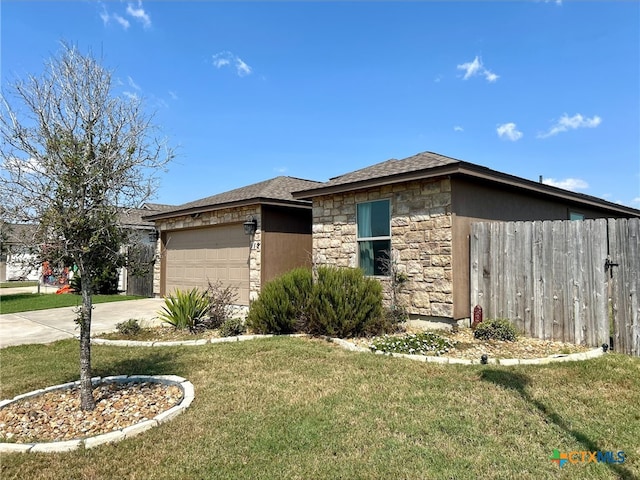 view of front of house with a garage and a front yard