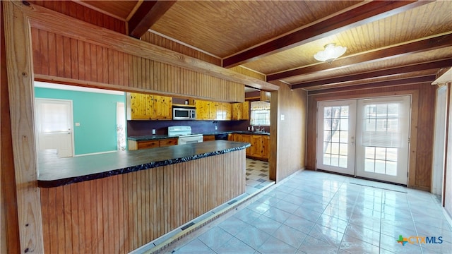 702 E Anaqua Ave, Victoria, TX 77901 - kitchen featuring stainless steel microwave, white electric range, dark countertops, french doors, and a wooden ceiling with exposed beams