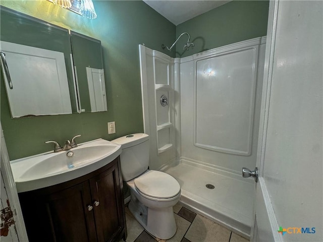 702 E Anaqua Ave, Victoria, TX 77901 - bathroom featuring vanity, a shower, and tile patterned floors