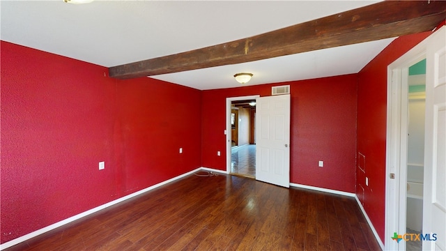 702 E Anaqua Ave, Victoria, TX 77901 - unfurnished room featuring wood finished floors, beam ceiling, and a textured wall
