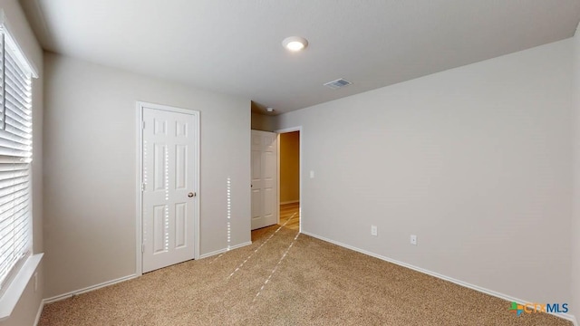 unfurnished bedroom featuring light colored carpet