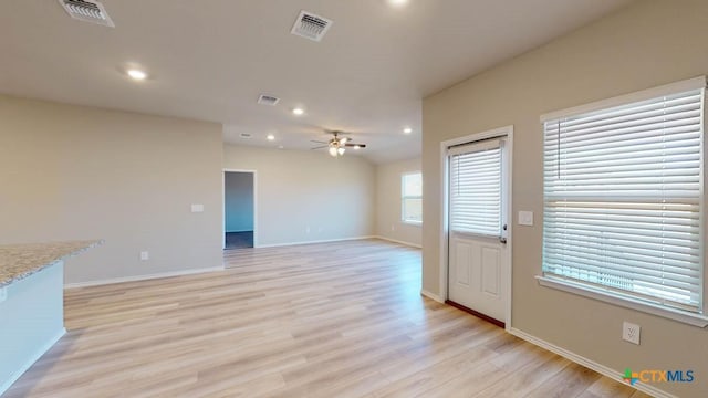 unfurnished living room featuring ceiling fan and light wood-type flooring