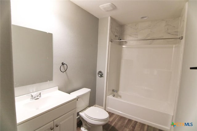 1027 County Road 274, Bertram, TX 78605 - bathroom featuring wood finished floors, vanity, toilet, and shower / tub combination