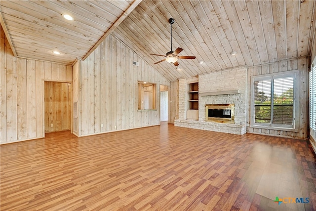 unfurnished living room featuring wooden ceiling, wood walls, a fireplace, wood-type flooring, and built in features