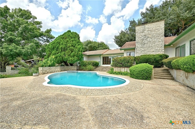 view of swimming pool with a patio area