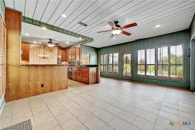 kitchen with wood walls, kitchen peninsula, wooden ceiling, and ceiling fan with notable chandelier