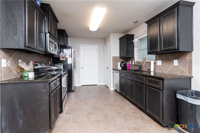 602 Dusty Trl, Belton, TX 76513 - kitchen featuring stainless steel appliances, dark stone countertops, backsplash, and light tile patterned floors