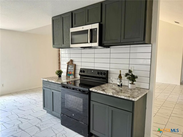 kitchen with black electric range oven, decorative backsplash, marble finish floor, and stainless steel microwave