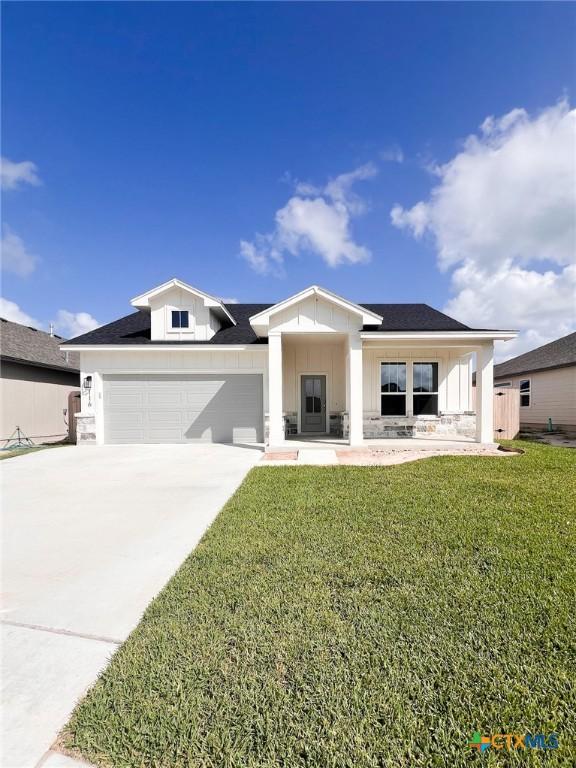 116 Raindance Ct, Victoria, TX 77904 - modern farmhouse featuring a front yard, an attached garage, concrete driveway, and board and batten siding