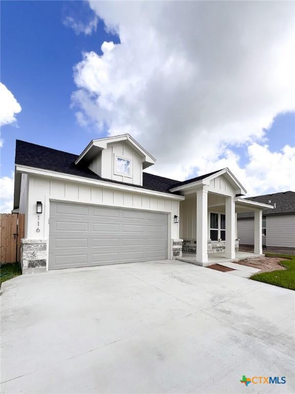 116 Raindance Ct, Victoria, TX 77904 - view of front facade with driveway, board and batten siding, covered porch, and an attached garage