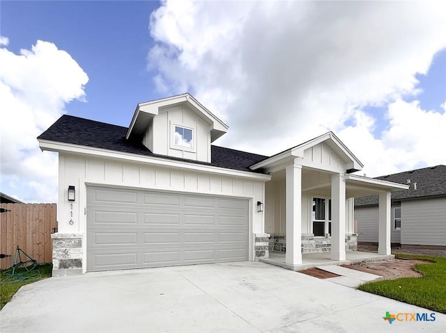 116 Raindance Ct, Victoria, TX 77904 - view of front of house with board and batten siding, concrete driveway, covered porch, and a shingled roof