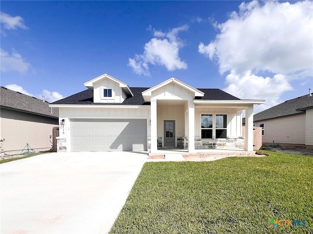 116 Raindance Ct, Victoria, TX 77904 - modern farmhouse style home featuring a front lawn, a garage, driveway, board and batten siding, and a porch