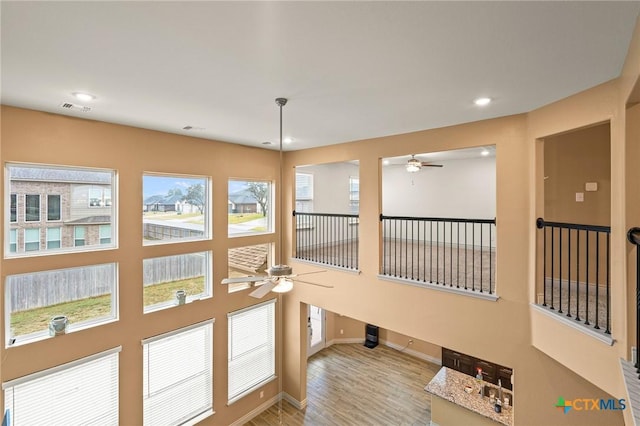 interior space with light wood-type flooring and a wealth of natural light