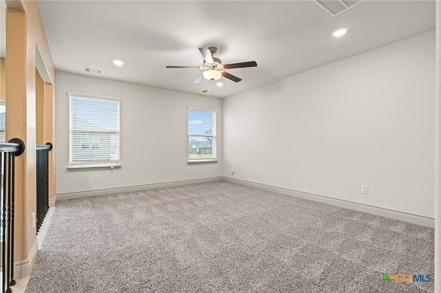 carpeted empty room featuring ceiling fan