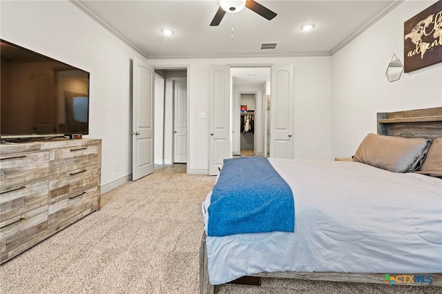 bedroom with ceiling fan, light colored carpet, and ornamental molding