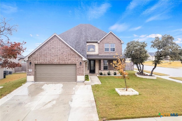 view of front of property featuring a garage and a front lawn