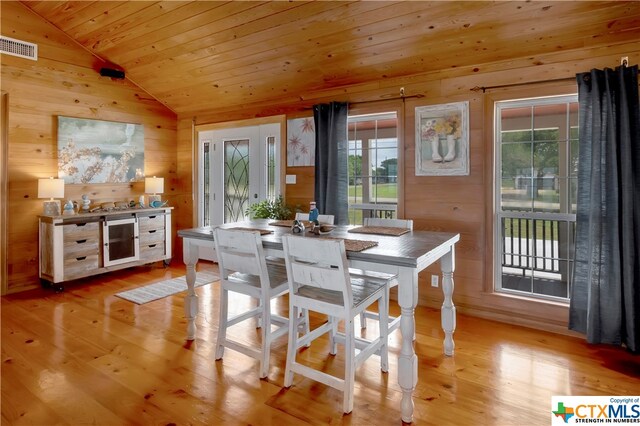 403 Bay St, Austwell, TX 77950 - dining area featuring light hardwood / wood-style flooring, lofted ceiling, wooden walls, and wooden ceiling