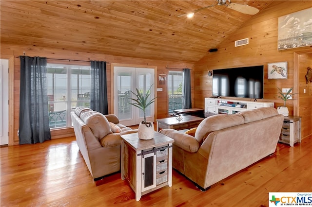 403 Bay St, Austwell, TX 77950 - living room with light hardwood / wood-style flooring, wood walls, ceiling fan, and wooden ceiling