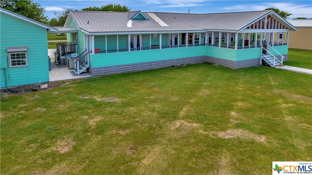 403 Bay St, Austwell, TX 77950 - rear view of house featuring a lawn and covered porch
