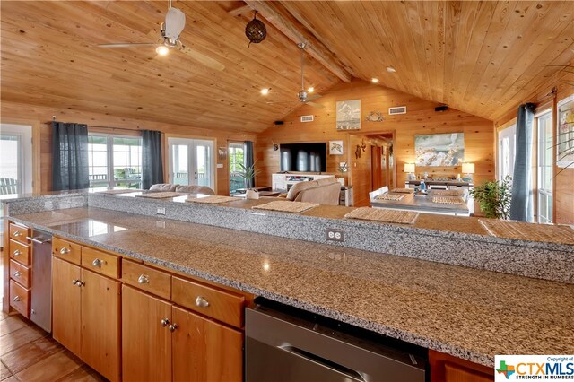 403 Bay St, Austwell, TX 77950 - kitchen with wooden ceiling, light stone countertops, ceiling fan, vaulted ceiling with beams, and wooden walls