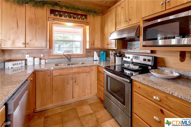 403 Bay St, Austwell, TX 77950 - kitchen featuring light stone countertops, wood ceiling, sink, and appliances with stainless steel finishes