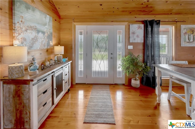 403 Bay St, Austwell, TX 77950 - doorway with wooden walls, vaulted ceiling, wooden ceiling, and light hardwood / wood-style floors