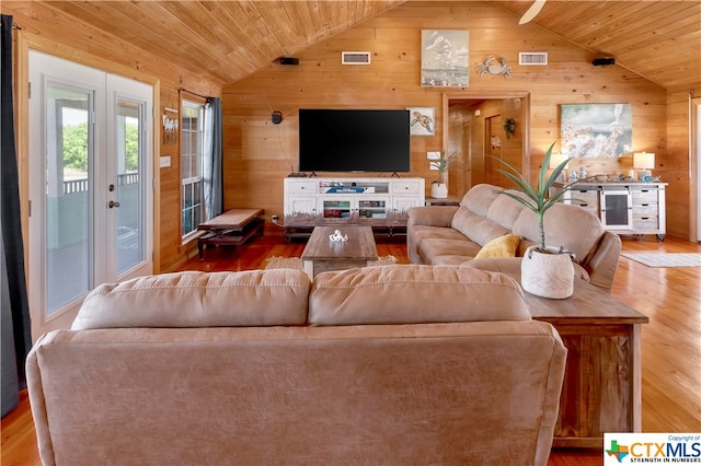 403 Bay St, Austwell, TX 77950 - living room with hardwood / wood-style flooring, wooden walls, and lofted ceiling