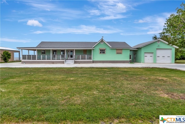 403 Bay St, Austwell, TX 77950 - view of front of property with a garage, a porch, and a front yard