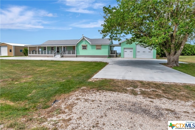 403 Bay St, Austwell, TX 77950 - ranch-style home featuring a garage, a porch, and a front yard