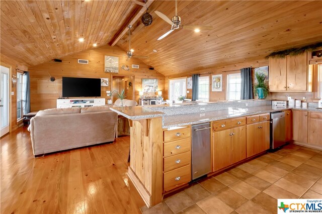 403 Bay St, Austwell, TX 77950 - kitchen featuring vaulted ceiling with beams, wooden walls, wooden ceiling, a breakfast bar, and light wood-type flooring