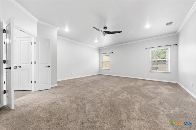 carpeted empty room featuring ceiling fan, plenty of natural light, and crown molding