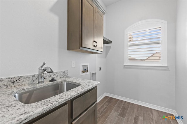 kitchen with light stone countertops and sink