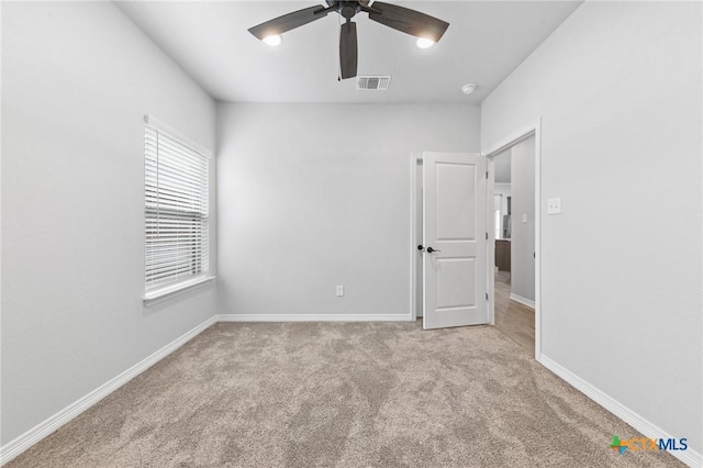 carpeted empty room with ceiling fan