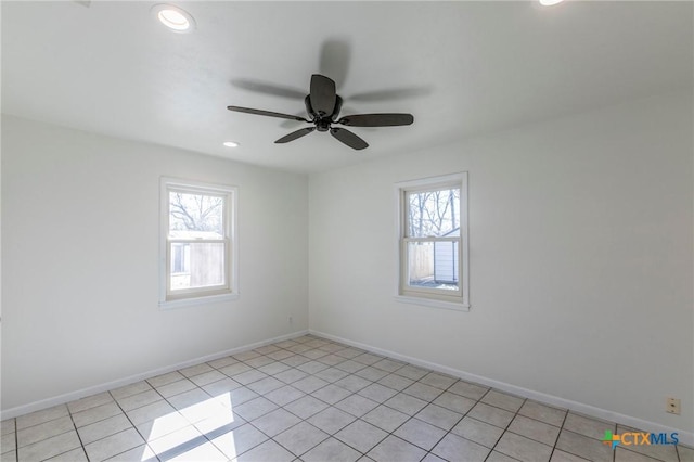 empty room featuring a wealth of natural light and baseboards