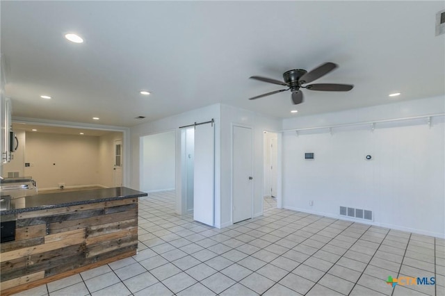 kitchen featuring recessed lighting, visible vents, and a barn door