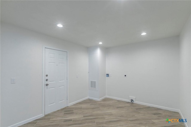 laundry room with baseboards, light wood-style flooring, visible vents, and hookup for an electric dryer