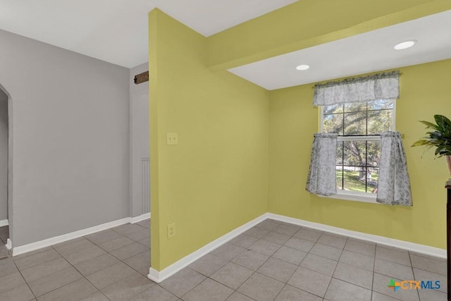 tiled spare room with recessed lighting and baseboards