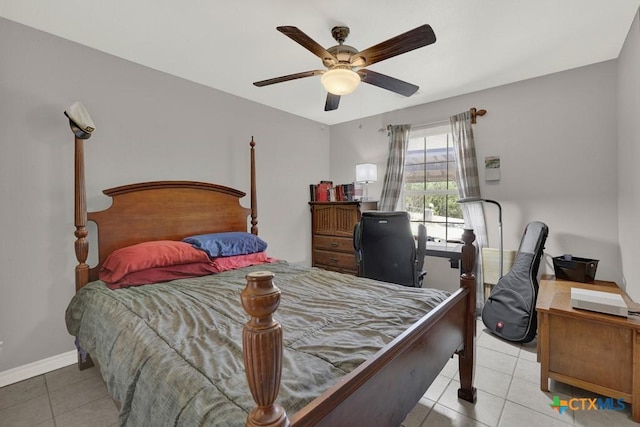 bedroom with a ceiling fan, baseboards, and tile patterned floors