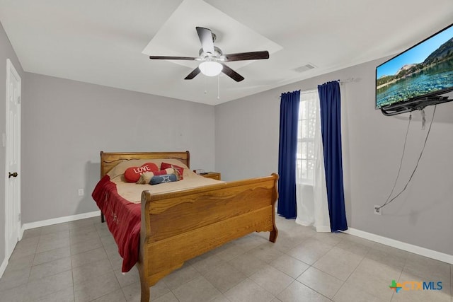 bedroom featuring a ceiling fan, light tile patterned flooring, visible vents, and baseboards